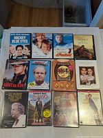 All 12 DVD cases laid out on table