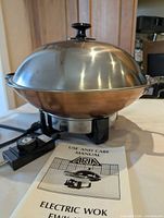 Electric wok assembled with lid, controller and manual visible