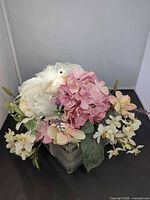 Front view showing pink hydrangea, white blossoms, glass block base and dove