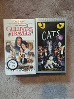 Front covers of Cats and Gulliver's Travels sealed VHS tapes