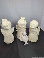 Group shot of three angels and one cherub