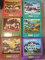 All six Charles Wysocki 1000-piece puzzle boxes front view
