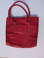 Front view of red textured tote bag