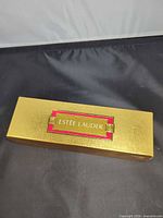 Closed gold Estée Lauder Small Wonders box