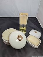 Full set showing perfume bottle, dusting powder, soap dish with bar