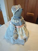 Front view of fabric mouse doorstop showing overall design, dress, bonnet, lace and ribbon details