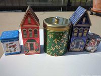 Front view of all five tins lined up