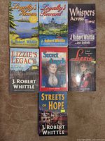 Front covers of all seven paperbacks