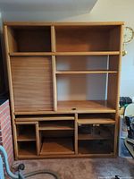 Full frontal view of entertainment center showing shelving layout