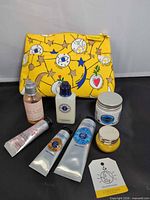 Full set of seven product containers and yellow pouch