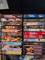 Front view of two-column rack filled with VHS tapes, showing all spines