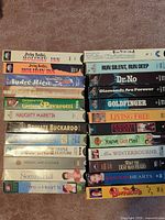 Two vertical stacks showing all 24 VHS titles