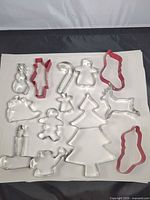 Group of metal Christmas cookie cutters on white background