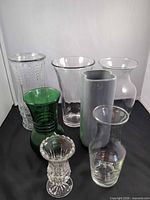 All seven vases grouped to show shapes, sizes and materials