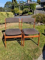 Pair of teak chairs front view showing upholstery and frame