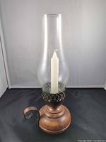 Front view of maple base hurricane lamp with glass chimney and candle