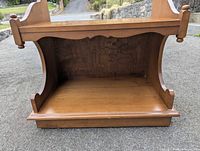 Front view showing scalloped apron and lower shelf