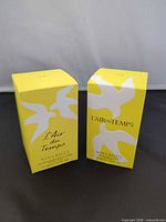 Front view of two sealed Nina Ricci L'Air du Temps body lotion boxes