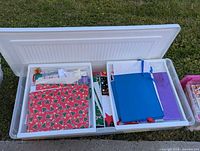 Overall view of Rubbermaid storage box open showing two insert trays filled with wrapping supplies