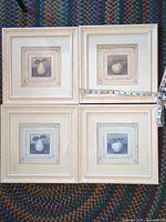 All four framed prints with measuring tape for scale