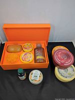 Overall contents showing gift box, two full-size body butters, travel tin and small bottle