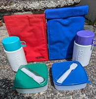 Group shot showing both lunch bags, both food jars, both food boxes