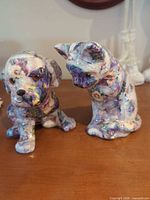 Dog and cat figurines side by side front-angle