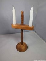 Front view of maple adjustable two-candle holder with candles inserted