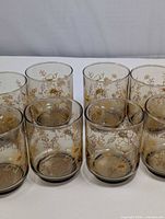 Front view of eight smoky amber floral juice glasses