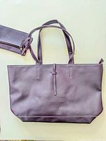 Front view of purple tote with attached wristlet