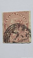 Front view of rose imperforate Queen Victoria Half Penny stamp with cancellation