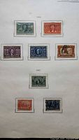 Full album page showing eight stamps with 1904 and 1907 labels