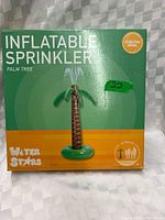Front of sealed Water Stars Inflatable Palm Tree Sprinkler box showing product image and branding
