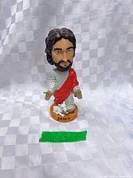 Front view of Jesus bobblehead showing overall appearance and base inscription
