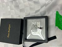 Fun Boutique black box with ribbon, display frame containing necklace