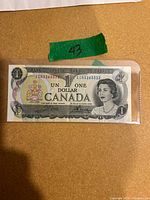 Obverse of Canadian $1 bill in sleeve showing entire note