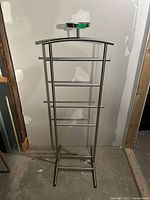 Full view of metal rack showing height and four bars