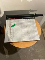 Top view showing gridded cutting surface, ruler, and cutting arm