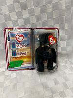 Open book showing packaged bear and printed The End pages