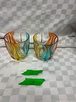 Front view of both multicolor swirled tumblers upright