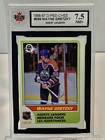 Front view of KSA-slabbed 1986-87 O-Pee-Chee Wayne Gretzky #259 Assist Leaders card showing label and card image