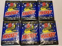 Seven blue Bowman Hockey wax packs arranged on surface