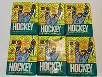 Group shot of six sealed 1990-91 O-Pee-Chee hockey card wax packs.