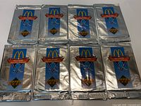 Eight sealed silver foil 1991-92 Upper Deck McDonald's All-Stars hockey card packs laid out