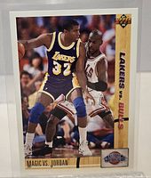 Front of 1991-92 Upper Deck #34 Magic Johnson vs Michael Jordan card in protective sleeve