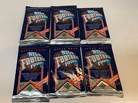 Six sealed 1991 Upper Deck NFL Football Premiere Edition packs arranged in two rows