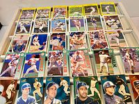 Assortment of baseball cards laid out showing different brands and designs