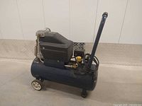 Full side view of Mastercraft 8-gallon air compressor showing tank, motor housing, handle, and wheels