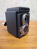 Front left view showing camera design and crank handle