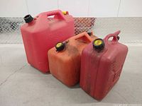 Front angle of three jerry cans showing sizes and caps